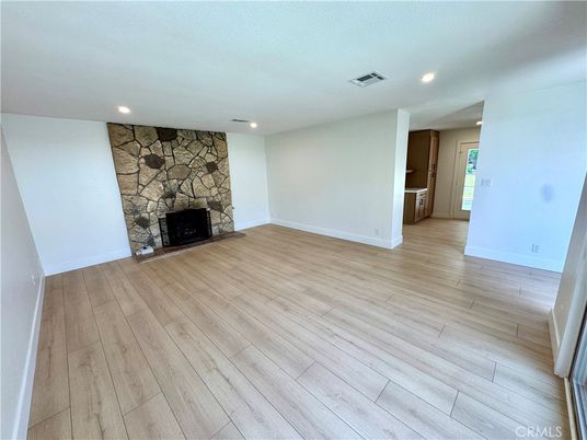 Empty room, Fireplace, Interior, Recessed Lighting, Stone Walls, Wood Texture Flooring