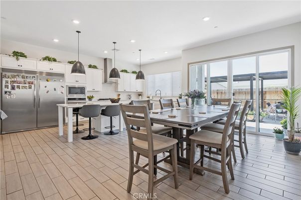 Dining room, Interior, Kitchen, Pendant Lights, Recessed Lighting, Stainless Steel Appliances, Wood Texture Flooring