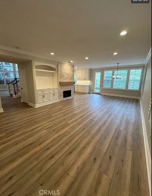 Empty room, Fireplace, Interior, Pendant Lights, Recessed Lighting, Stone Walls, Wood Texture Flooring