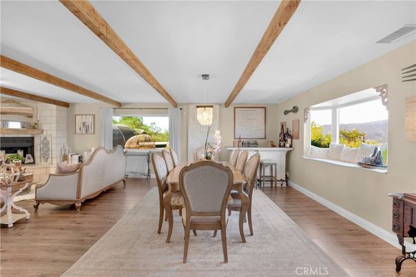 Chandelier, Dining room, Fireplace, Interior, Living room, Stone Walls, Wooden Beams, Wood Texture Flooring