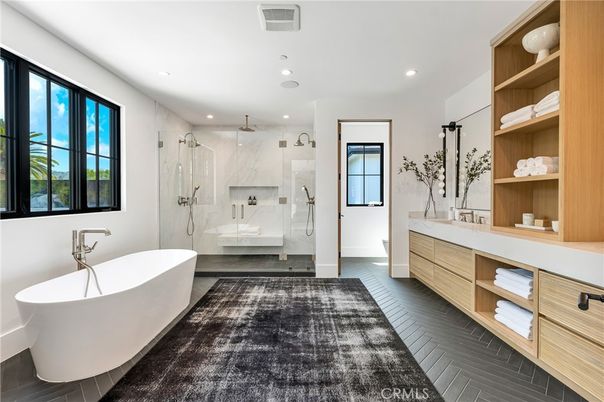 Bathroom, Dual Sink Vanities, Free Standing Baths, Glass Shower, Interior, Marble Walls, Recessed Lighting, Wood Texture Flooring