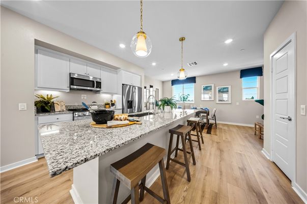 Dining room, Interior, Kitchen, Pendant Lights, Recessed Lighting, Stainless Steel Appliances, Wood Texture Flooring