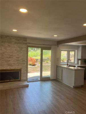 Empty room, Fireplace, Interior, Kitchen, Recessed Lighting, Stone Walls, Wood Texture Flooring