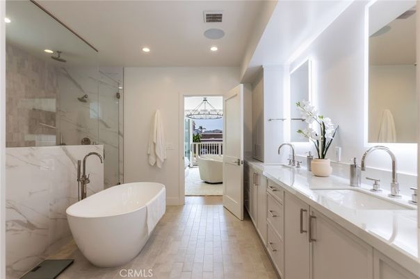 Bathroom, Dual Sink Vanities, Free Standing Baths, Glass Shower, Interior, Marble Walls, Recessed Lighting, Wood Texture Flooring
