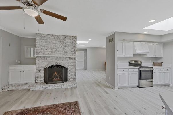 Fireplace, Interior, Kitchen, Recessed Lighting, Stainless Steel Appliances, Stone Walls, Wood Texture Flooring