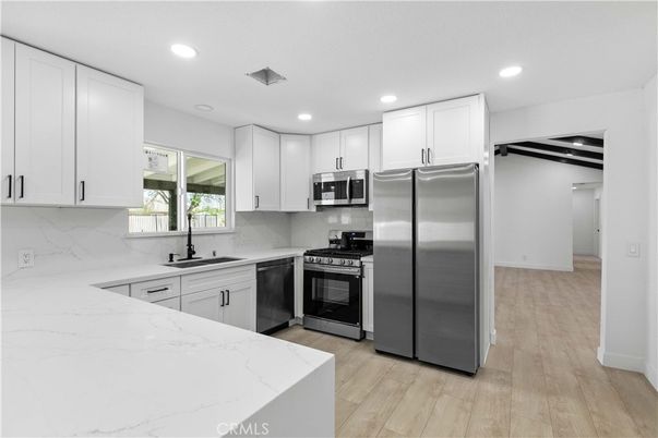 Interior, Kitchen, Marble Walls, Recessed Lighting, Stainless Steel Appliances, Wood Texture Flooring