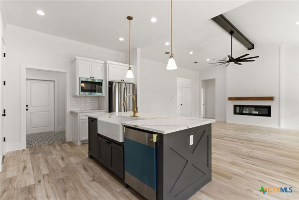 Fireplace, Interior, Kitchen, Pendant Lights, Recessed Lighting, Stainless Steel Appliances, Wood Texture Flooring
