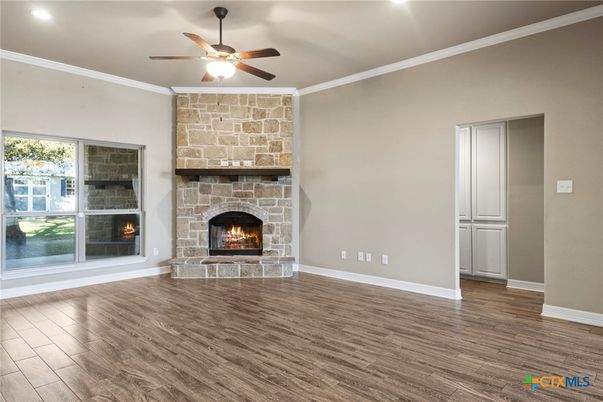 Empty room, Fireplace, Interior, Recessed Lighting, Stone Walls, Wood Texture Flooring