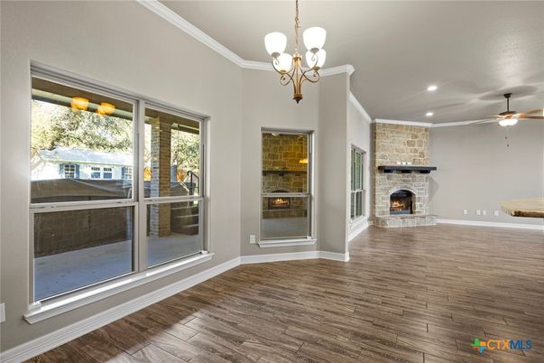 Chandelier, Empty room, Fireplace, Interior, Recessed Lighting, Stone Walls, Wood Texture Flooring