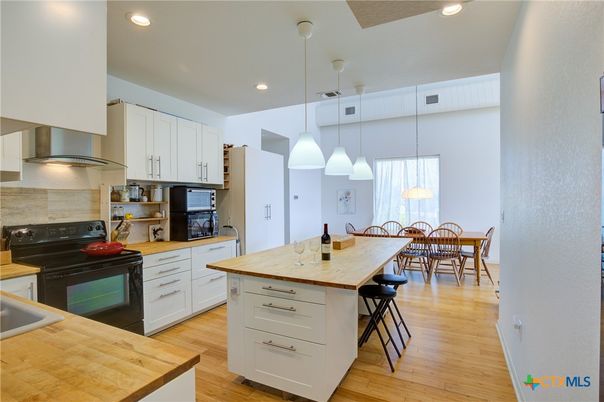 Dining room, Interior, Kitchen, Pendant Lights, Recessed Lighting, Stainless Steel Appliances, Wood Texture Flooring
