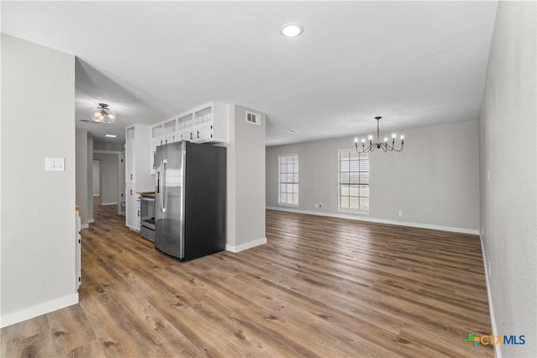 Chandelier, Empty room, Interior, Kitchen, Pendant Lights, Recessed Lighting, Stainless Steel Appliances, Wood Texture Flooring