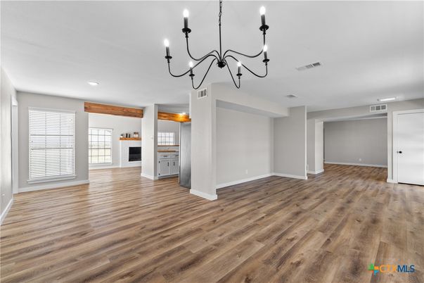 Chandelier, Empty room, Fireplace, Interior, Recessed Lighting, Wood Texture Flooring