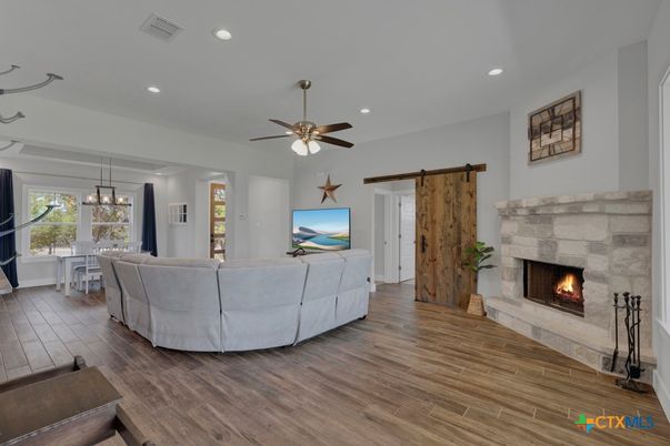 Dining room, Fireplace, Interior, Living room, Pendant Lights, Recessed Lighting, Wood Texture Flooring