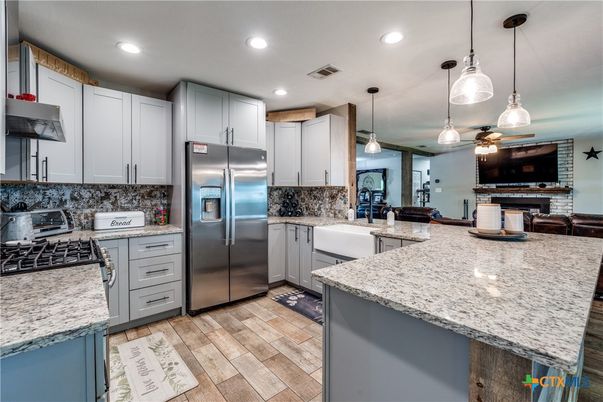 Fireplace, Interior, Kitchen, Pendant Lights, Recessed Lighting, Stainless Steel Appliances, Wood Texture Flooring