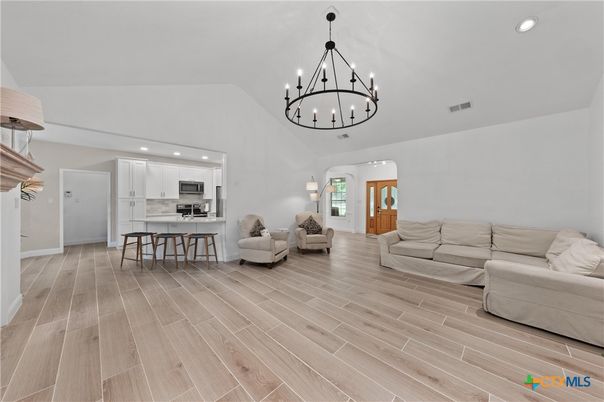 Chandelier, Interior, Kitchen, Living room, Pendant Lights, Recessed Lighting, Stainless Steel Appliances, Wood Texture Flooring