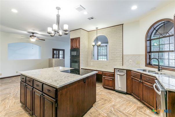 Chandelier, Interior, Kitchen, Recessed Lighting, Stainless Steel Appliances, Stone Walls, Wood Texture Flooring