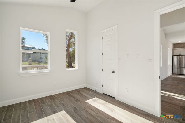 Empty room, Interior, Kitchen, Recessed Lighting, Stainless Steel Appliances, Wood Texture Flooring