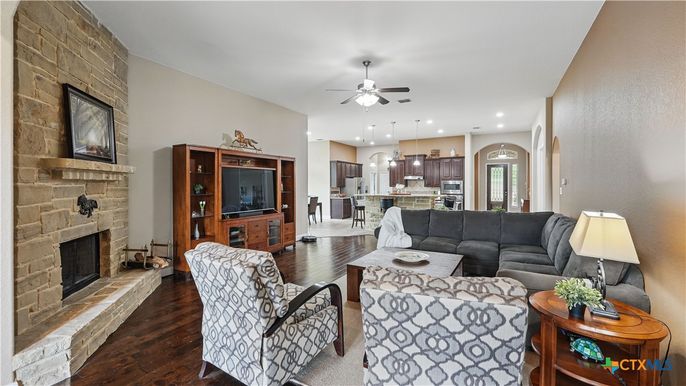 Fireplace, Interior, Kitchen, Living room, Pendant Lights, Recessed Lighting, Stainless Steel Appliances, Stone Walls, Wood Texture Flooring