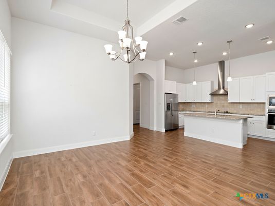 Chandelier, Empty room, Interior, Kitchen, Pendant Lights, Recessed Lighting, Stainless Steel Appliances, Wood Texture Flooring