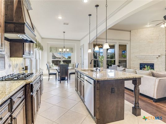 Chandelier, Dining room, Fireplace, Interior, Kitchen, Living room, Pendant Lights, Recessed Lighting, Stainless Steel Appliances, Stone Walls