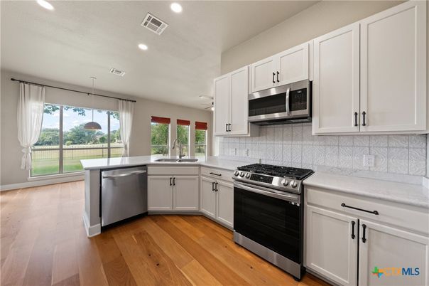 Interior, Kitchen, Pendant Lights, Recessed Lighting, Stainless Steel Appliances, Wood Texture Flooring