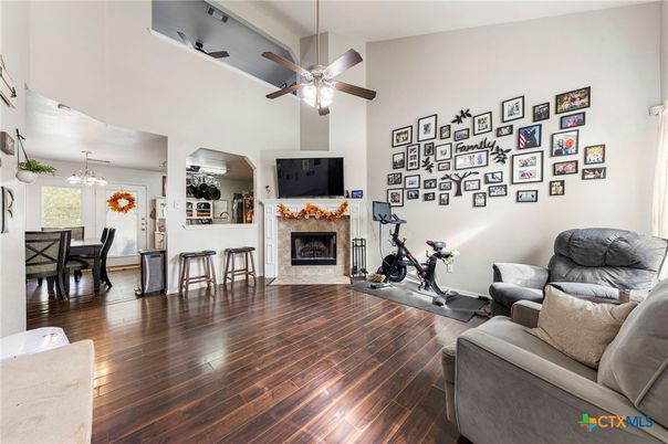 Dining room, Fireplace, Fitness Equipment, Interior, Living room, Pendant Lights, Wood Texture Flooring