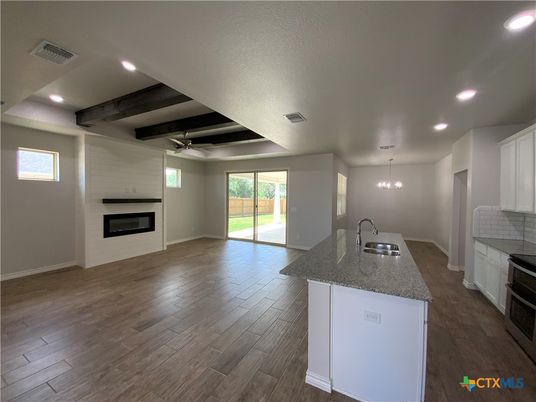 Empty room, Fireplace, Interior, Kitchen, Pendant Lights, Recessed Lighting, Wooden Beams, Wood Texture Flooring