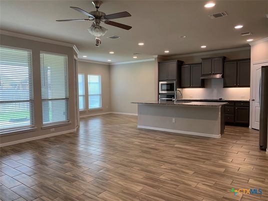 Empty room, Interior, Kitchen, Recessed Lighting, Stainless Steel Appliances, Wood Texture Flooring