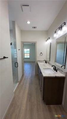 Bathroom, Dual Sink Vanities, Glass Shower, Interior, Recessed Lighting, Wood Texture Flooring