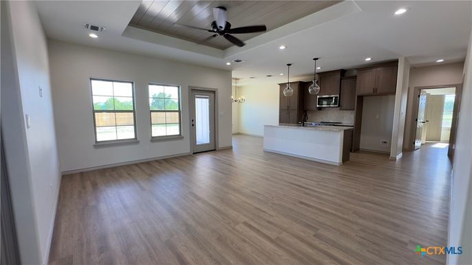 Empty room, Interior, Kitchen, Pendant Lights, Recessed Lighting, Stainless Steel Appliances, Wood Texture Flooring