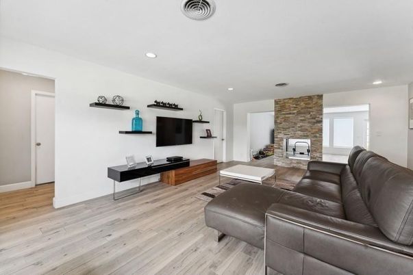 Fireplace, Interior, Living room, Recessed Lighting, Stone Walls, Wood Texture Flooring