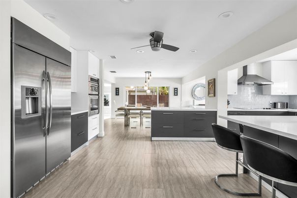 Chandelier, Dining room, Interior, Kitchen, Pendant Lights, Recessed Lighting, Stainless Steel Appliances, Wood Texture Flooring