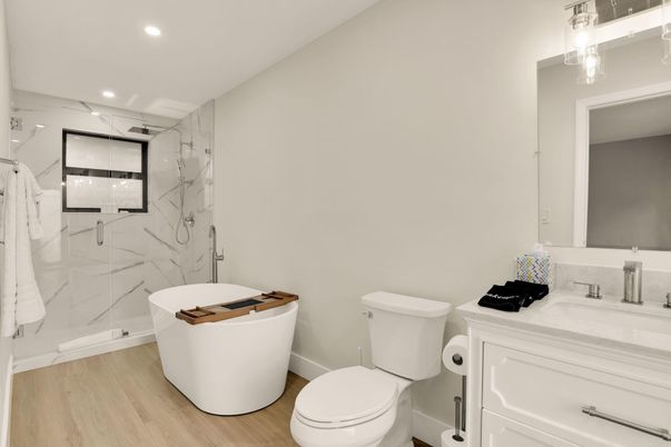 Bathroom, Free Standing Baths, Glass Shower, Interior, Marble Walls, Recessed Lighting, Wood Texture Flooring