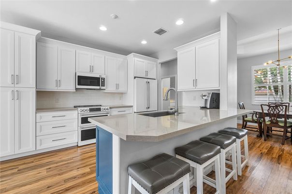 Dining room, Interior, Kitchen, Pendant Lights, Recessed Lighting, Stainless Steel Appliances, Wood Texture Flooring