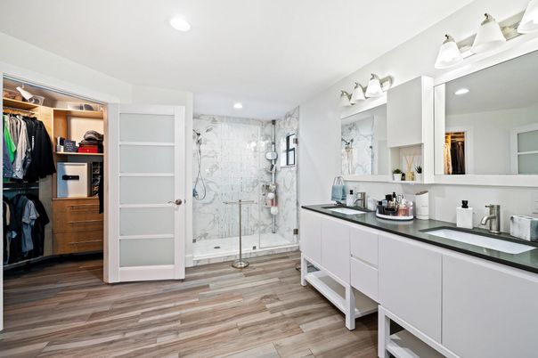 Bathroom, Dual Sink Vanities, Glass Shower, Interior, Marble Walls, Recessed Lighting, Walk-in Closets, Wood Texture Flooring