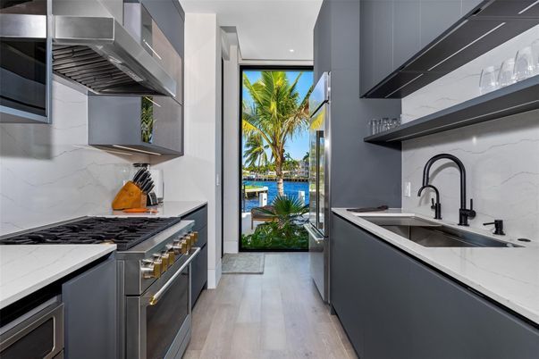 Interior, Kitchen, Marble Walls, Recessed Lighting, Stainless Steel Appliances, Wood Texture Flooring