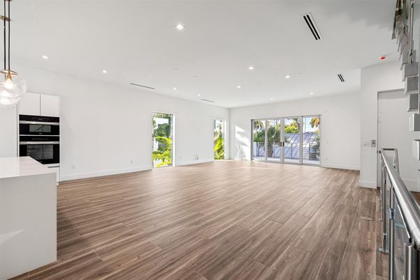 Empty room, Interior, Kitchen, Pendant Lights, Recessed Lighting, Stainless Steel Appliances, Wood Texture Flooring