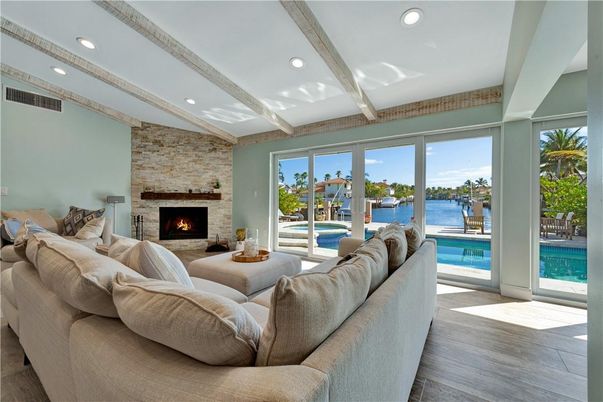 Fireplace, Interior, Living room, Recessed Lighting, Stone Walls, Water, Wood Texture Flooring