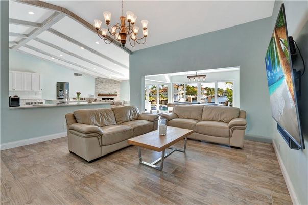 Chandelier, Fireplace, Interior, Kitchen, Living room, Recessed Lighting, Stone Walls, Wood Texture Flooring