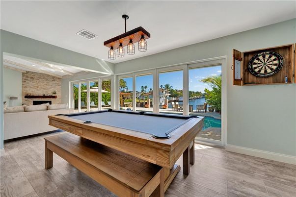 Billiard Table, Fireplace, Game Room, Interior, Pendant Lights, Stone Walls, Water, Wood Texture Flooring