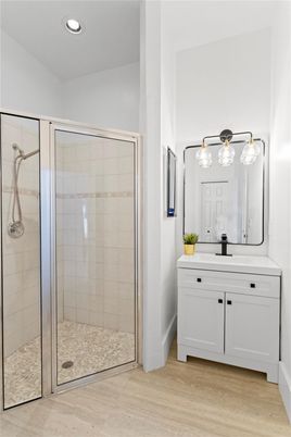 Bathroom, Glass Shower, Interior, Pendant Lights, Recessed Lighting, Wood Texture Flooring