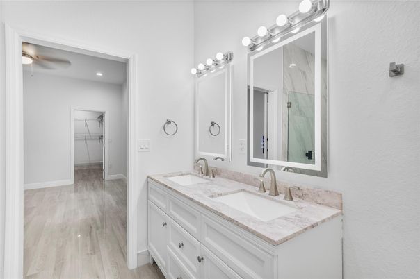 Bathroom, Dual Sink Vanities, Interior, Marble Walls, Recessed Lighting, Wood Texture Flooring