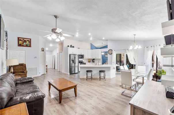 Chandelier, Dining room, Interior, Kitchen, Living room, Pendant Lights, Recessed Lighting, Stainless Steel Appliances, Wood Texture Flooring