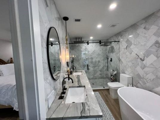 Bathroom, Dual Sink Vanities, Free Standing Baths, Glass Shower, Interior, Marble Walls, Recessed Lighting, Wood Texture Flooring