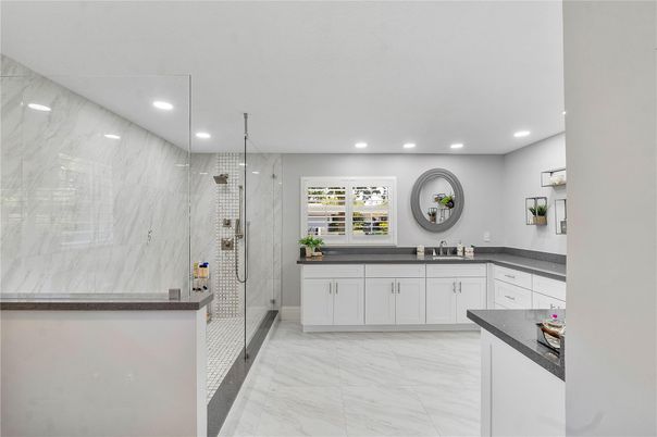 Bathroom, Dual Sink Vanities, Glass Shower, Interior, Marble, Marble Walls, Recessed Lighting