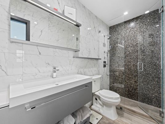 Bathroom, Glass Shower, Interior, Marble Walls, Recessed Lighting, Wood Texture Flooring