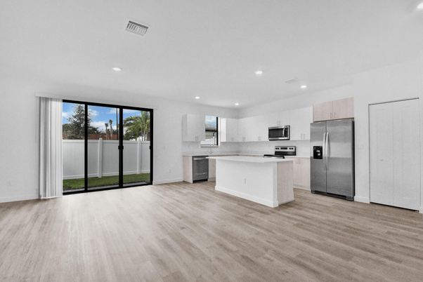 Empty room, Interior, Kitchen, Recessed Lighting, Stainless Steel Appliances, Wood Texture Flooring