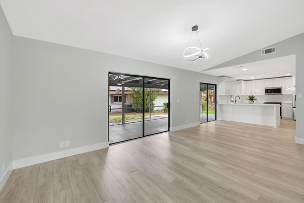 Empty room, Interior, Kitchen, Pendant Lights, Recessed Lighting, Stainless Steel Appliances, Wood Texture Flooring