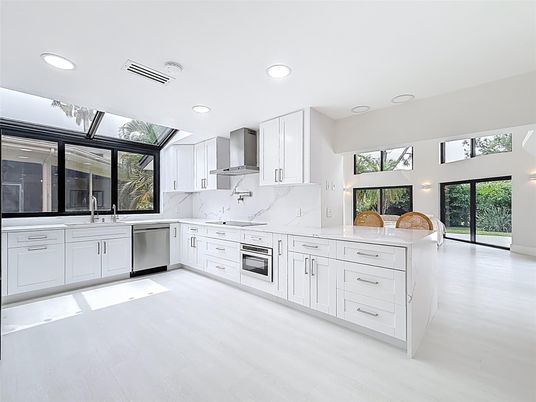 Interior, Kitchen, Marble Walls, Recessed Lighting, Stainless Steel Appliances, Wood Texture Flooring