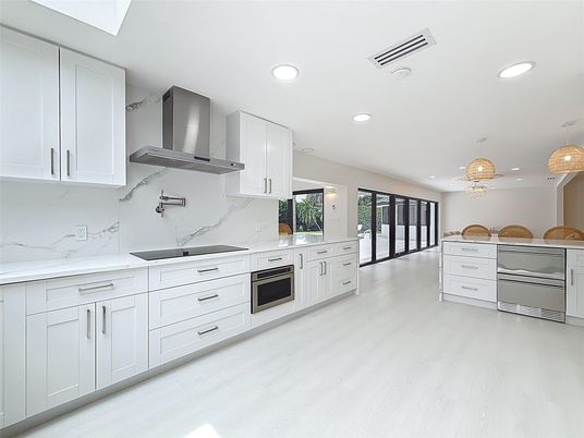 Chandelier, Interior, Kitchen, Marble Walls, Pendant Lights, Recessed Lighting, Stainless Steel Appliances, Wood Texture Flooring